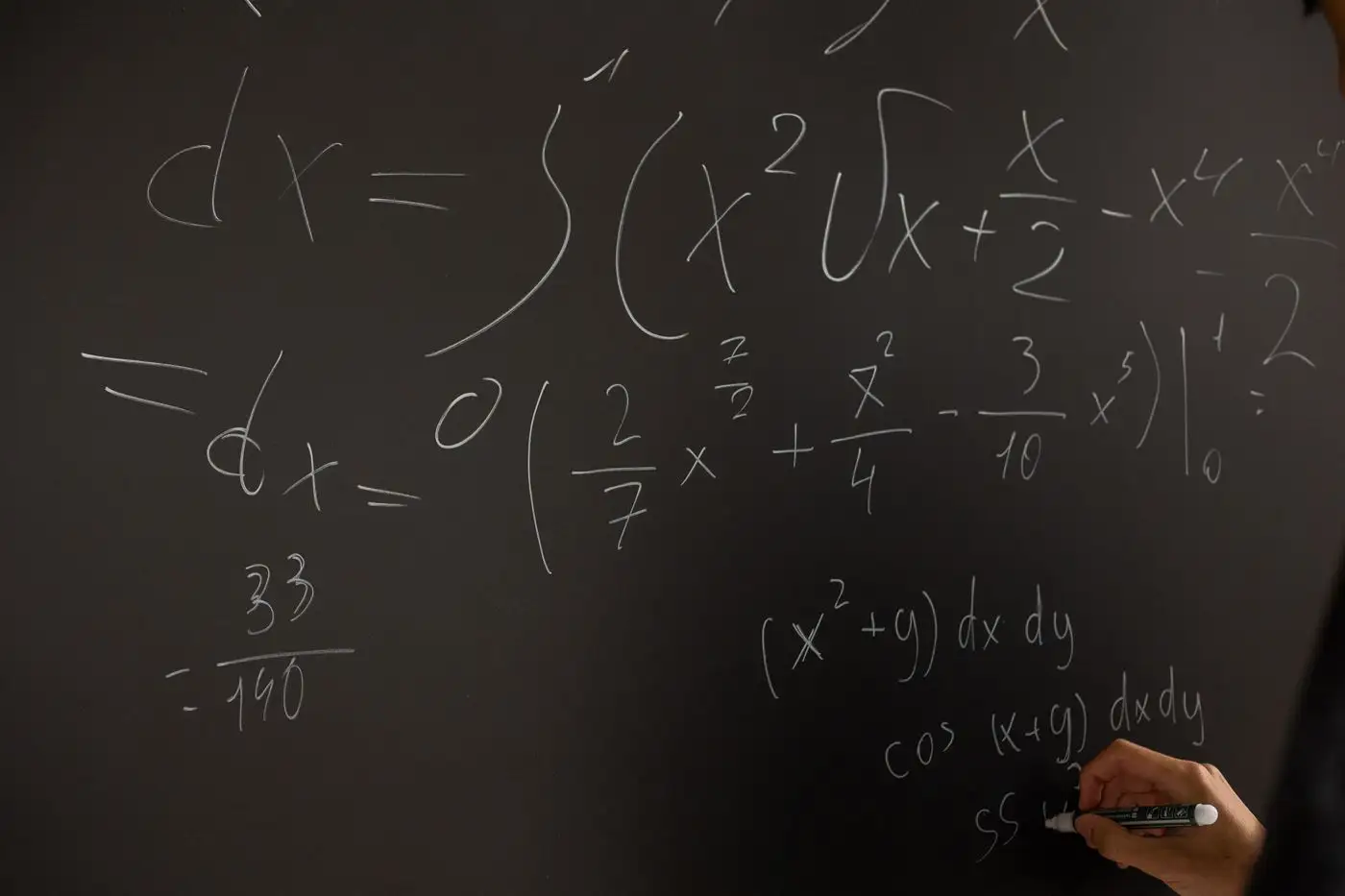 Equations and working written in chalk across a blackboard.