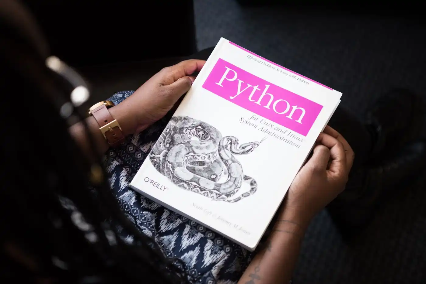 A reading set held open in both hands.